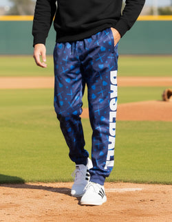 Navy blue baseball warmup pants featuring vertical white Baseball text and crossed bats pattern.
