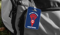 Personalized lacrosse bag tag with a red lacrosse head, player number, and name on a blue background.