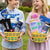 Two children holding gift baskets outdoors in a garden setting.