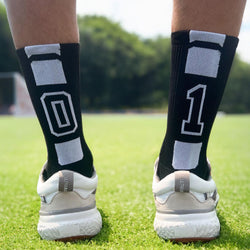 Black crew lacrosse socks featuring woven white player number 01 on the back.