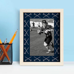 Wooden lacrosse picture frame featuring navy blue mat with white crossed sticks pattern.