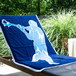 Navy blue lacrosse beach towel featuring a large white player silhouette graphic.