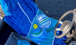 Blue pickleball car seat towel featuring large paddle and ball graphics.