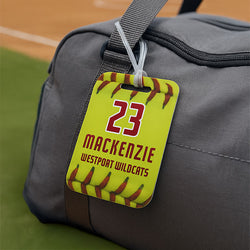 Yellow softball bag tag featuring red stitching graphics and personalized team name and player number.