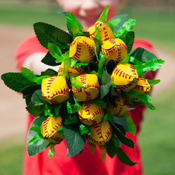 Softball rose bouquet featuring realistic yellow softball blossoms with red stitching and green leaves.