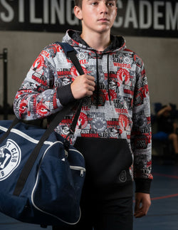 Youth wearing a performance wrestling hoodie featuring a pattern of wrestler graphics and Eat Sleep Wrestle text.