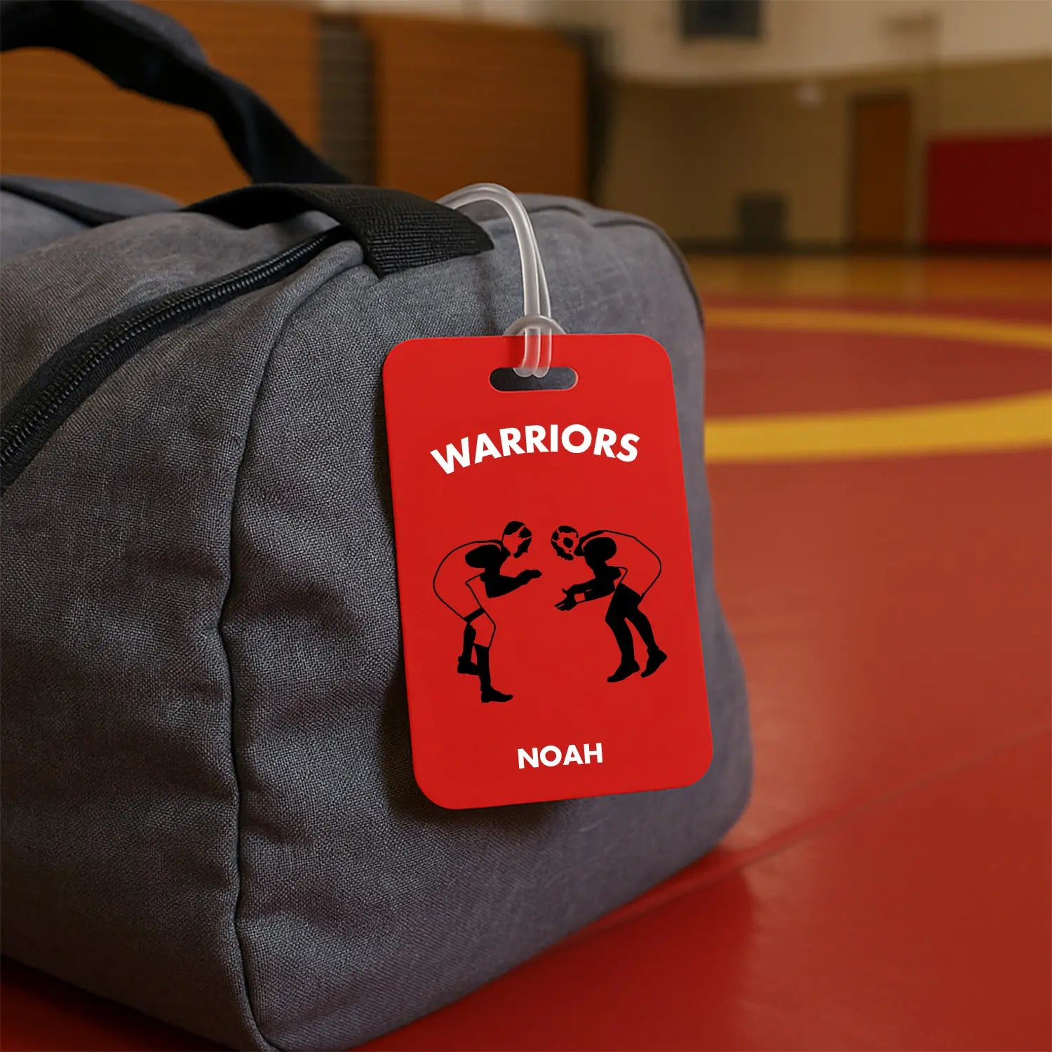 Gray bag with a red 'Warriors' tag featuring silhouettes of people and the name 'Noah'