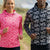 Two people wearing patterned running hoodies outdoors with a scenic background