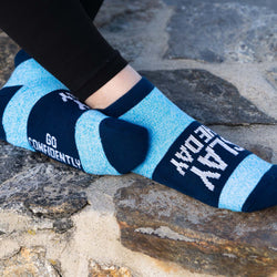 Slay The Day motivational ankle socks worn by a person on a stone walkway