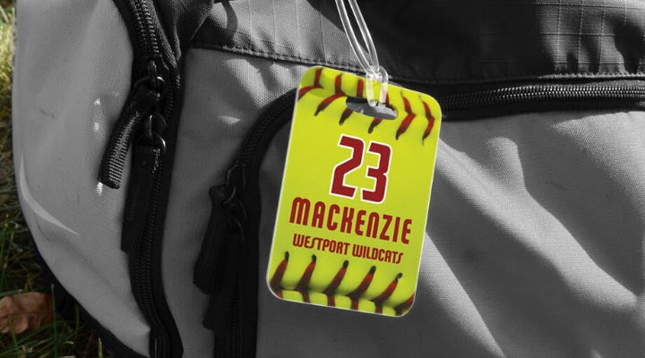Personalized softball bag tag featuring yellow ball design, player number, and name