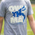Youth wearing a gray wrestling t-shirt featuring Own The Mat slogan and blue wrestler silhouette.