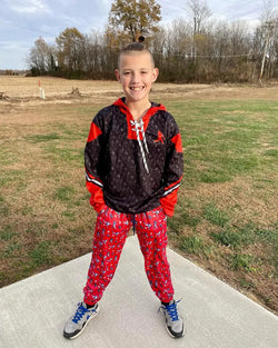 Boy wearing a baseball themed hoodie and lounge pants