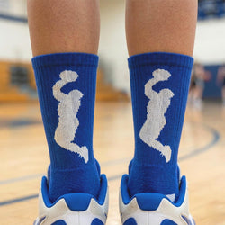 Blue socks with white basketball graphics worn on a basketball court