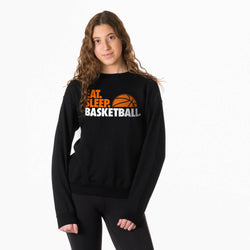Person wearing a black sweatshirt with 'Eat. Sleep. Basketball.' text and basketball graphic.