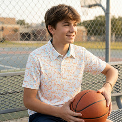 Young boy holding a basketball on a basketball court