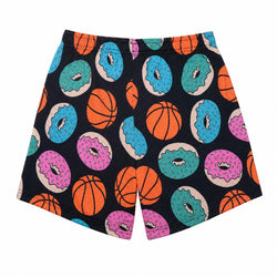 A pair of athletic shorts featuring a playful all-over print of orange basketballs and colorful donuts (pink, blue, and teal) on a black background, shown flat against a white backdrop.