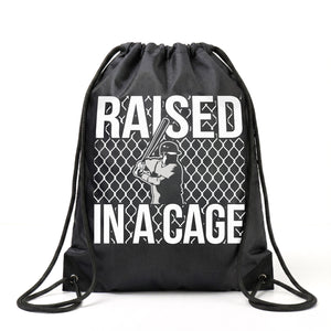 Black drawstring bag with 'Raised in a Cage' text and graphic on a white background