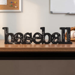 Decorative word 'baseball' with signatures on a shelf in a room setting.