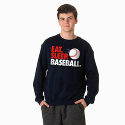 Person wearing a navy sweatshirt with 'Eat. Sleep. Baseball.' text and a baseball graphic on a white background