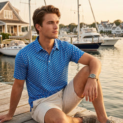 Teen wearing a baseball patterned polo shirt outdoors by a pier.