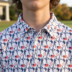 Person wearing a polo shirt with sports-themed pattern including baseballs, flags, and athletes.