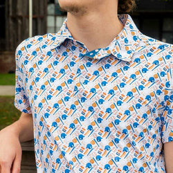 Young man wearing a baseball themed polo shirt outdoors