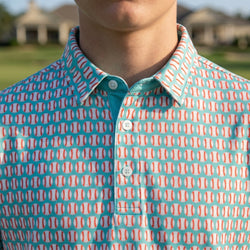 Close up on collar of a blue polo shirt with baseball pattern.