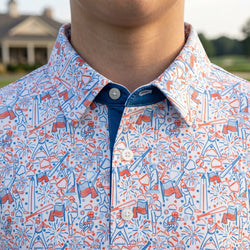 Close up of a person wearing a polo shirt with patriotic baseball pattern.