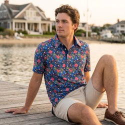 Person wearing a tropical themed baseball polo shirt on a pier.