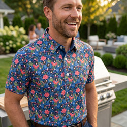 Person wearing a tropical themed polo shirt with baseball pattern at an outdoors cookout.