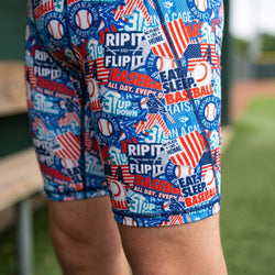 Baseball-themed shorts with text and graphics on a grassy field background