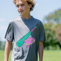 Kid wearing a t-shirt with a colorful graphic of a baseball bat and donut outdoors