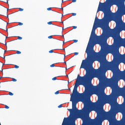 Close-up of a baseball-themed fabric or material swatch showing red and blue baseball stitching on a white section and white baseballs on a navy blue section.