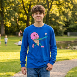 Person wearing a blue long-sleeve shirt with a colorful ice cream baseball graphic in a park setting