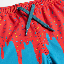 Colorful swim shorts with a red and blue design on a white background