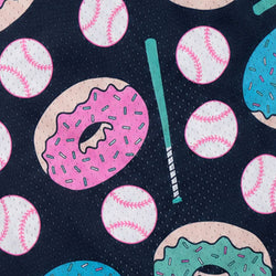 A close-up of a fabric pattern featuring baseballs and donuts on a dark navy mesh background, with a mint green baseball bat.