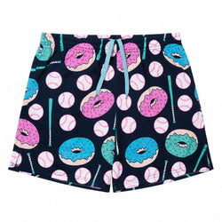 A pair of shorts featuring a playful pattern of pink and blue donuts, baseballs, and teal batons on a dark navy mesh fabric. The shorts have an elastic waistband with a matching teal drawstring.