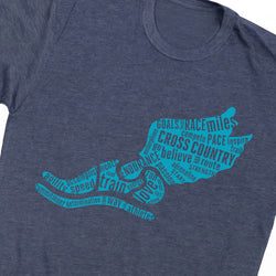 A close-up of a heathered navy blue t-shirt featuring a bright turquoise graphic of a running shoe silhouette filled with motivational cross-country running words like 'GOALS', 'MILES', 'CROSS', 'COUNTRY', and 'INSPIRE'.