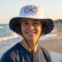 Person wearing a hockey themed bucket hat with a beach and ocean in the background