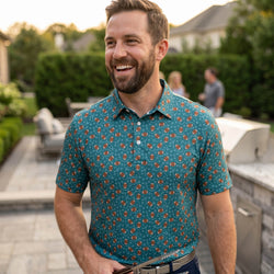 Man wearing a football patterned polo shirt outdoors at a bbq.