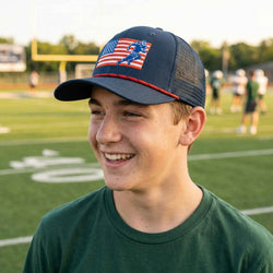 Person wearing a cap with an American flag design on a football field
