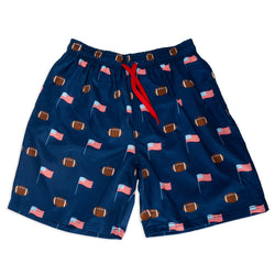 Navy swim shorts with football and flag pattern on a white background