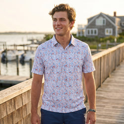 Person wearing a patriotic patterned polo shirt with football graphics.