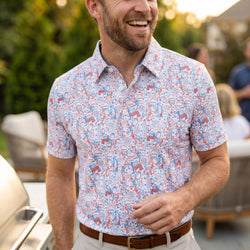 Person wearing a patriotic themed football polo shirt outdoors at a cookout.