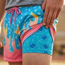 Colorful football shorts with a flame design on a blurred background