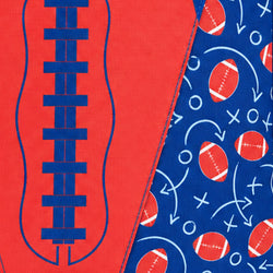 A close-up of a gootball fabric pattern featuring a red background with a blue football seam design on the left and a blue background with red footballs and white play symbols on the right.