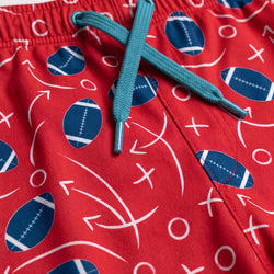 Red shorts with blue football pattern 
