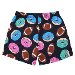 A pair of black athletic shorts featuring a colorful pattern of donuts and footballs in pink, blue, and teal, displayed flat against a white background.
