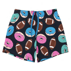 A pair of athletic shorts featuring a playful pattern of pink, blue, and teal frosted donuts and brown footballs on a black background, complete with a blue drawstring.
