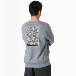 A man viewed from behind wearing a heather gray crewneck sweatshirt with a large vintage football graphic on the back that reads 'OPEN SEASON'.